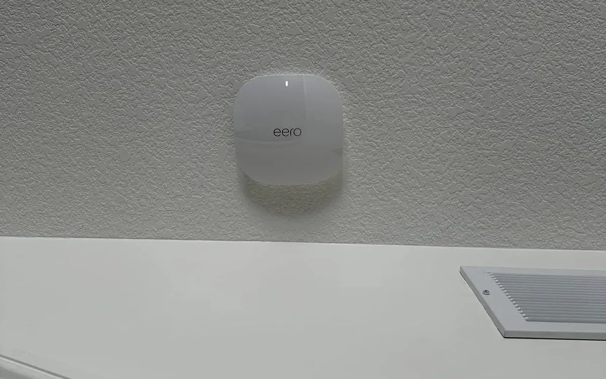 Mesh WiFi access point wall-mounted near ceiling